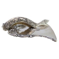 Silver crumb set w/ floral 
scroll reliefs around monogram card