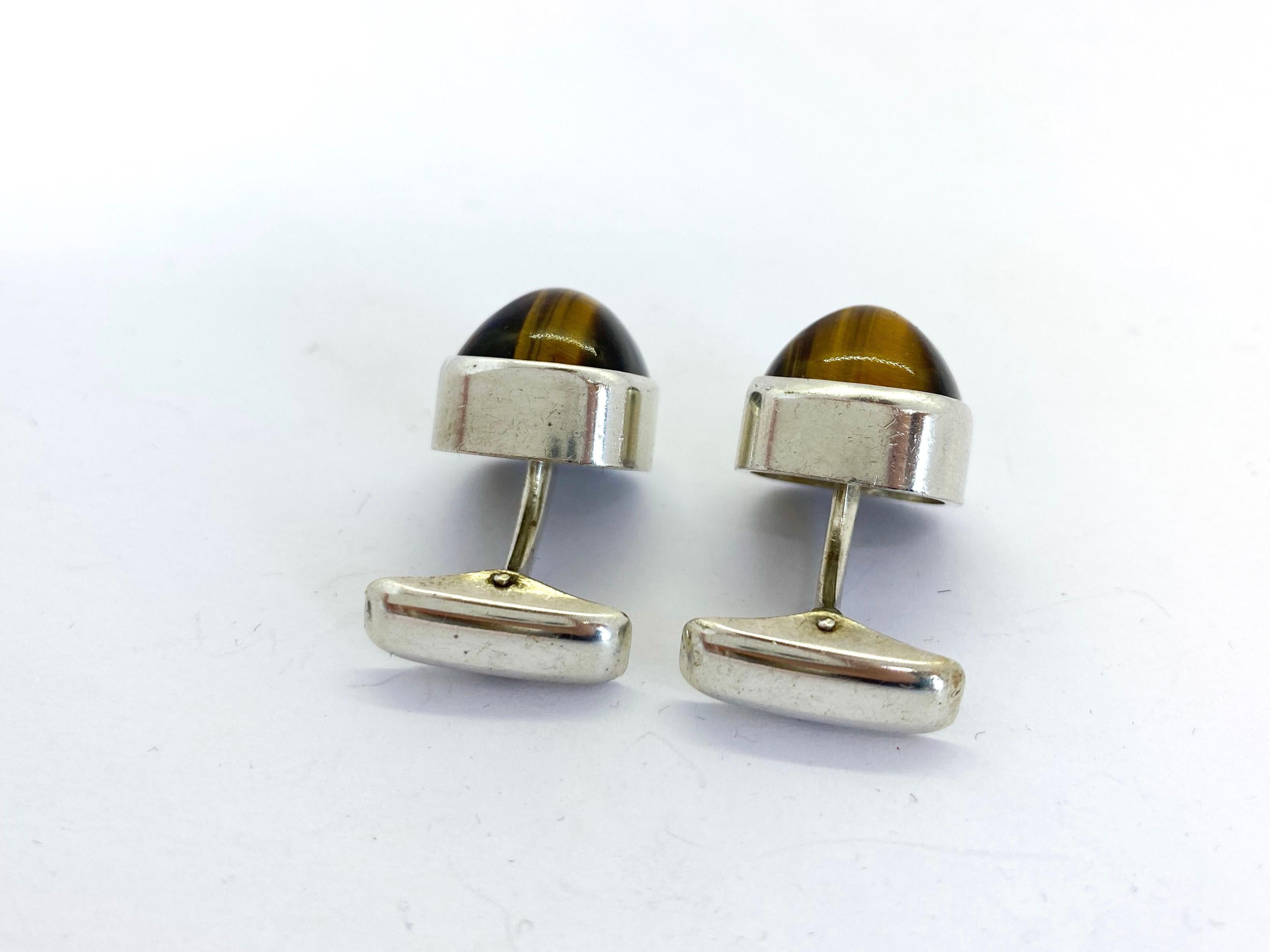 Silver Cufflinks by Elis Kauppi for Kupittaan Kulta, Finland, Tiger eye stone
Made in Finland in 1960 in Turku
813H Silver and Tiger eye Stone
Check stamped.
