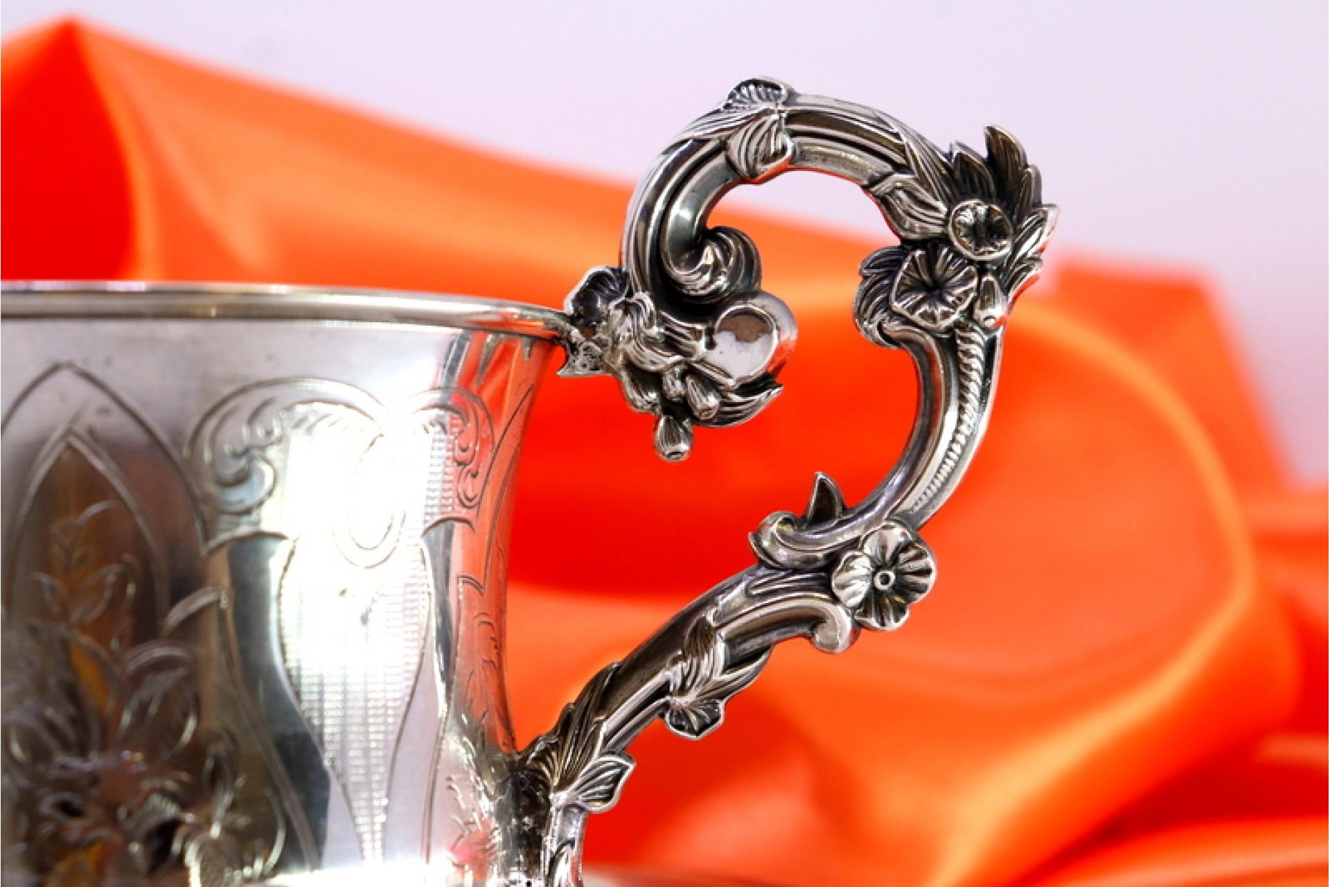 European Silver cup and saucer with floral engravings and raised handle details For Sale