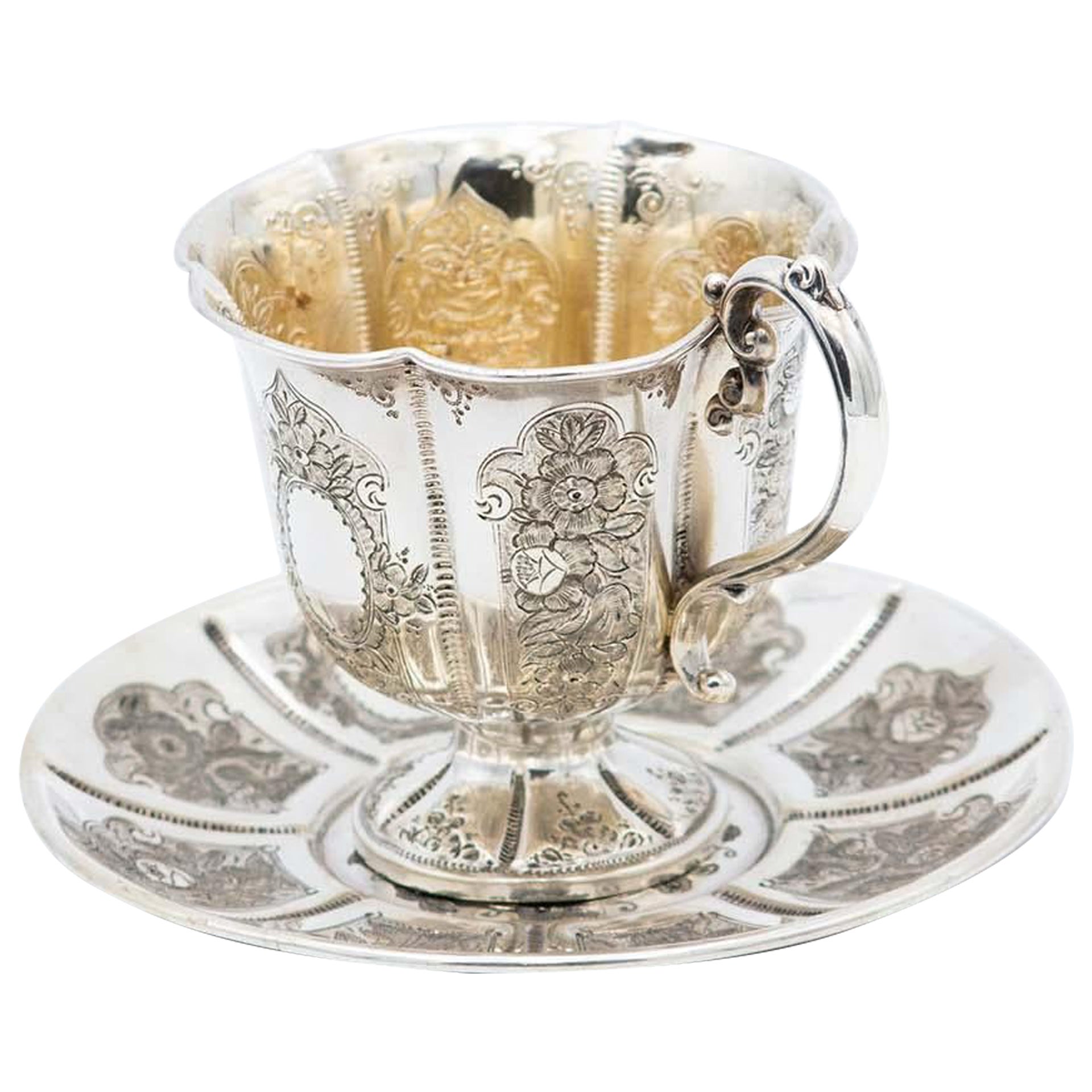 Silver cup and saucer with floral motifs