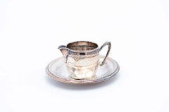 Silver cup and saucer with reliefs and friezes