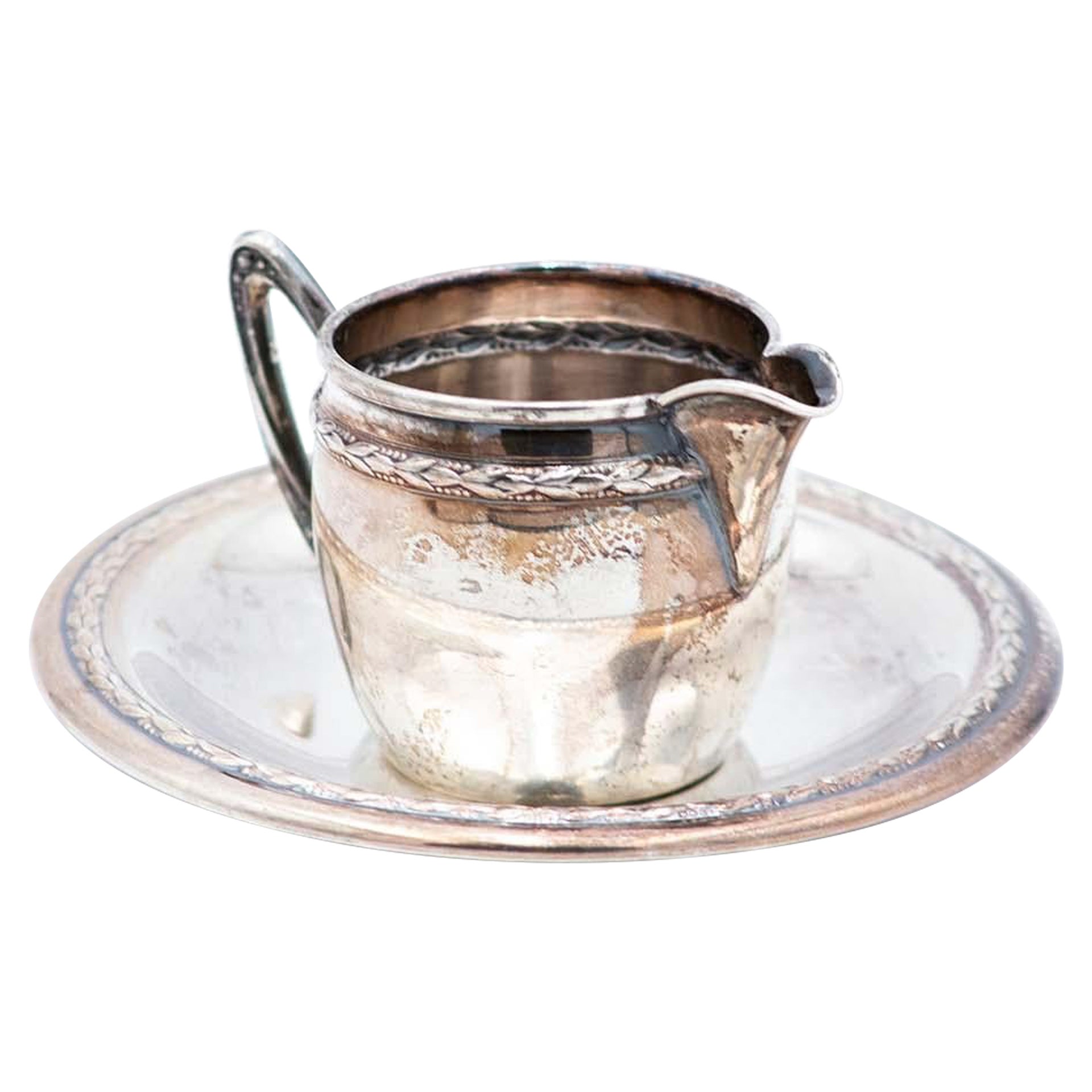 Silver cup and saucer with reliefs and friezes