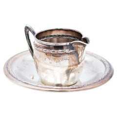 Silver cup and saucer with reliefs and friezes