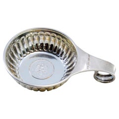 Silver cup for wine tasting with Mexican currency inside