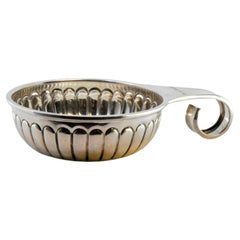 Silver cup for wine tasting with Mexican currency inside