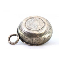 Silver cup with coin reliefs on the bottom for wine tasting