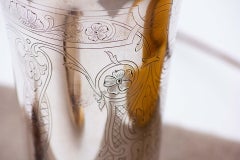 Silver cup with engraved floral motifs and raised frieze on the base