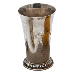 Silver cup with engraved floral motifs and raised frieze on the base