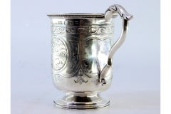 Silver cup with engraved monogram cartouche and acanthus-covered handle