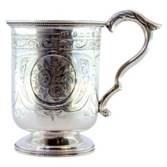 Silver cup with engraved monogram cartouche and acanthus-covered handle