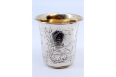 Silver cup with engravings of flowers, leaves and landscape