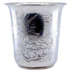 Silver cup with engravings of flowers, leaves and landscape