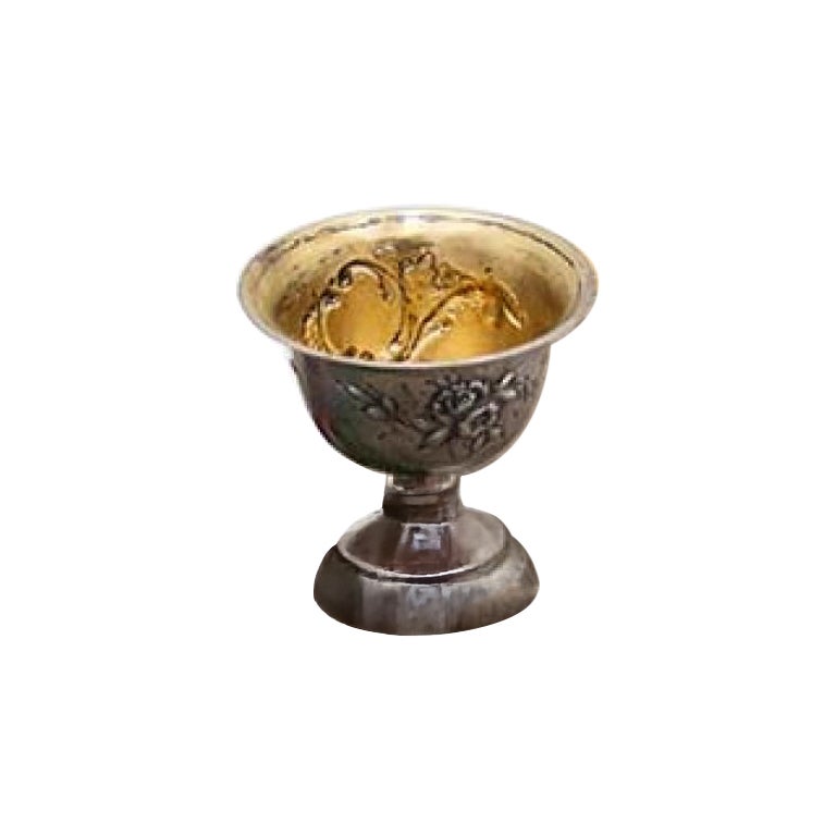 Silver cup with floral reliefs, frieze base and gold interior