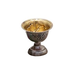 Silver cup with floral reliefs, frieze base and gold interior