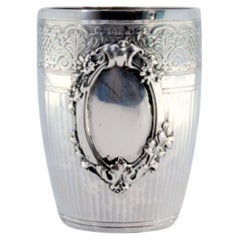 Silver cup with fluted trim, garlands and monogram card