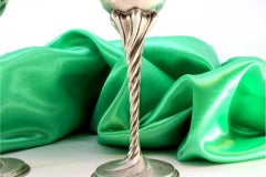 Silver cups w/ high stems & twists on circular bases w/ engraved plant motifs