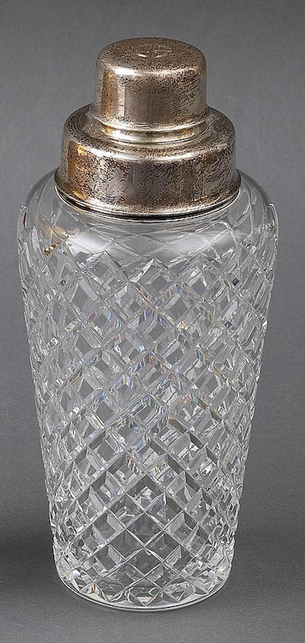 Silver cut glass cocktail shaker. Sterling silver rim, silver plate lid and shot glass cover, rim marked ''Tiffany & Co. Makers, Sterling, 23258, 1947-1956.