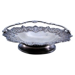 Silver cut-out basket with shells, palms and tilting handle