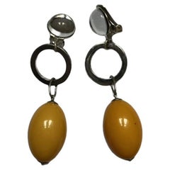 Silver Dangling Clip-on Earrings with Yellow Bakelite Pendant by Roger Scemama