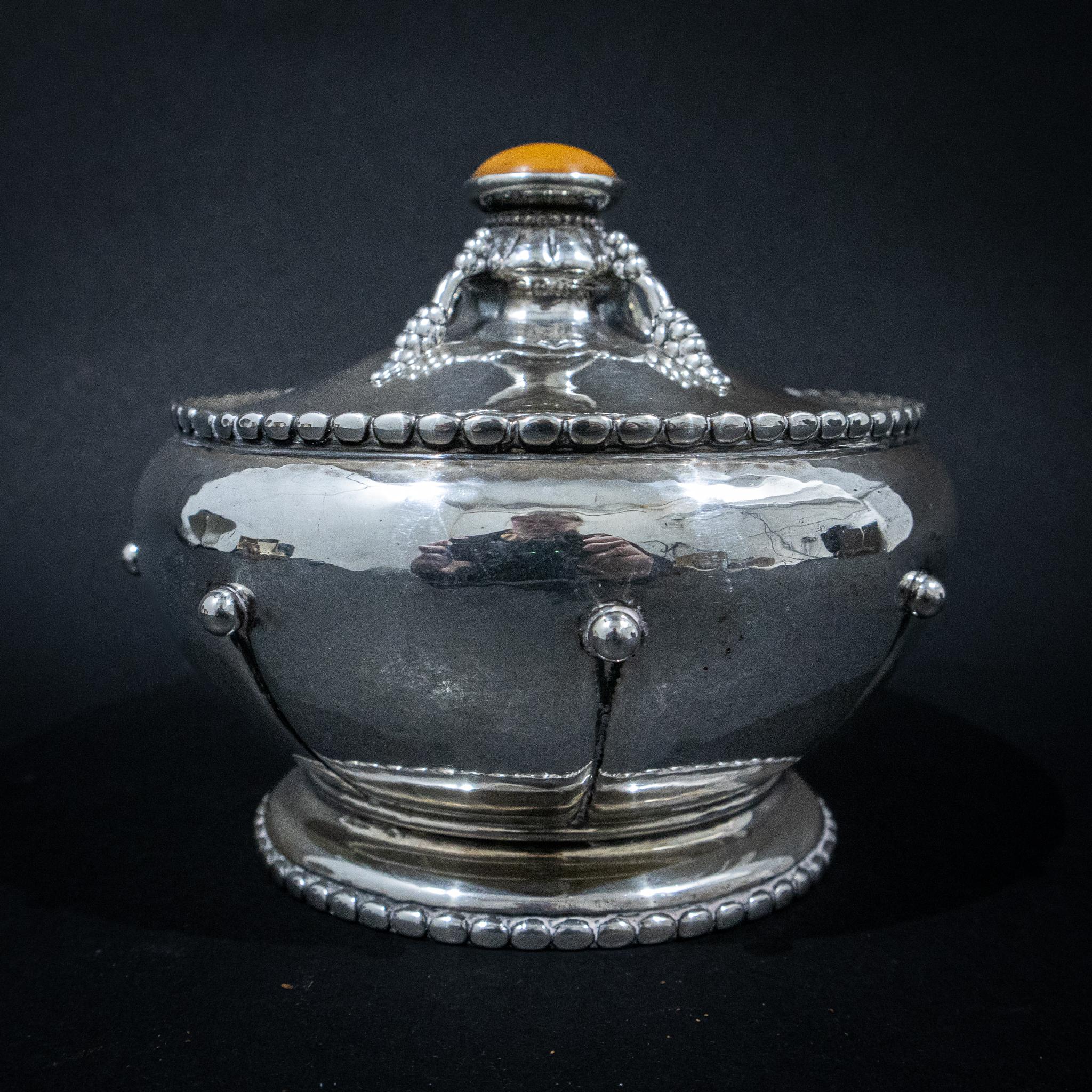 Silver Danish Arts & Crafts Bowl & Cover. A fabulous piece of silver from the renowned Danish silversmith Christian F Heise. The bowl has some wonderful features. The body is circular with a hand hammered finish with beaded panels to the sides, a