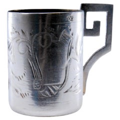 Silver digestive cup with engravings and question-mark-shaped handle