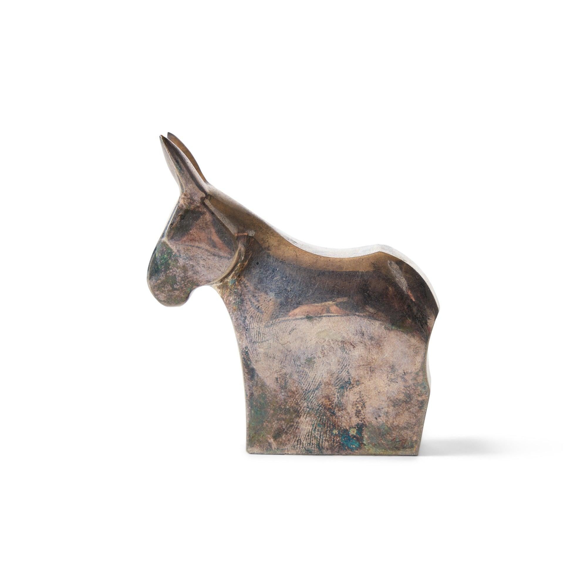 A petite silver plated figurine depicting a donkey. Marked 