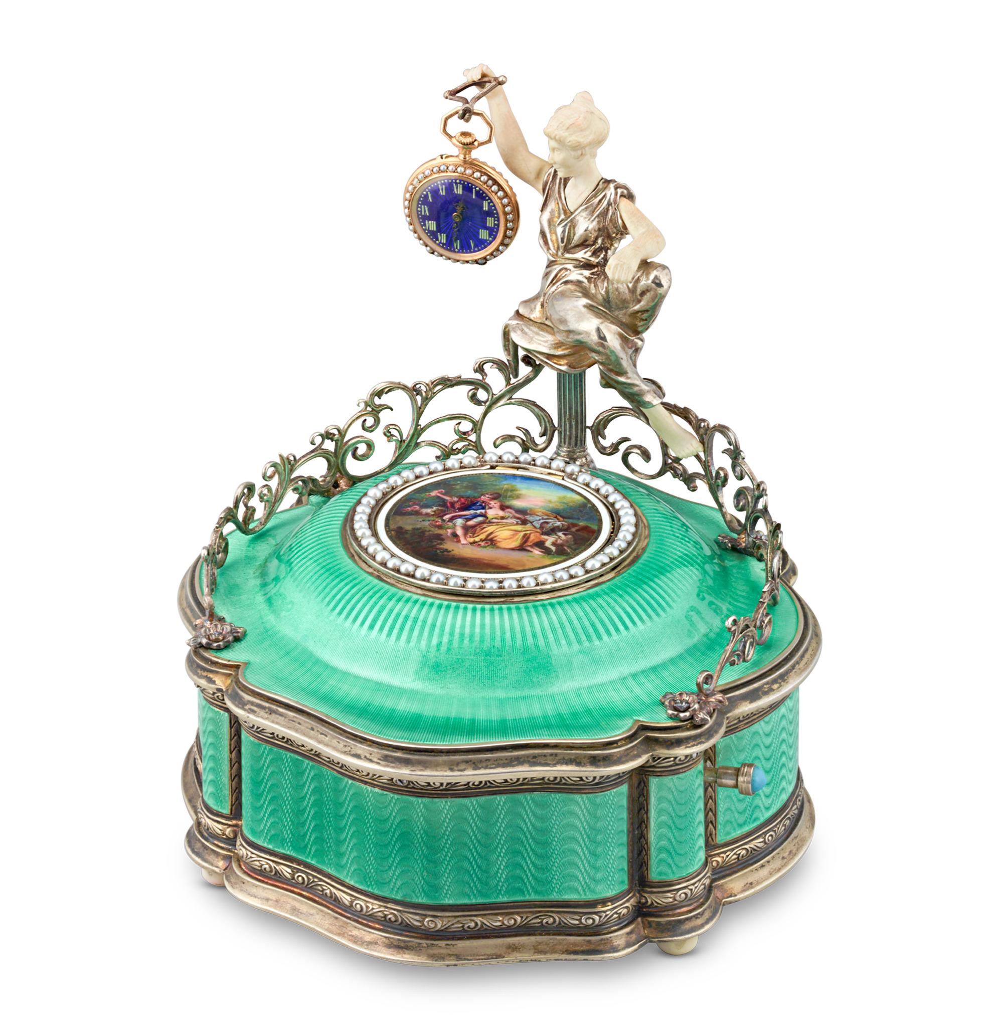 One of the rarest examples of a mechanical bird box, this extraordinary box features not one, but two brilliantly colored love birds crafted with genuine hummingbird feathers. When the lid is opened, the delightful pair begin to sing their sweet,
