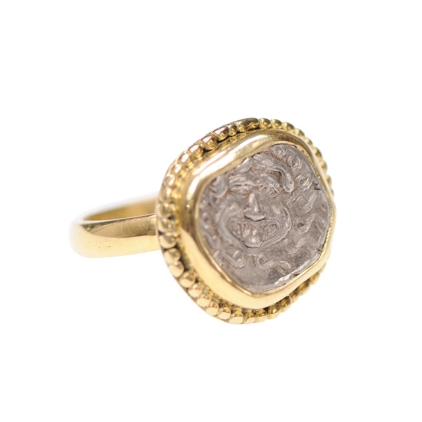 A silver Drachma [coin] from Thrace, Apollonia Pontika, circa 4th century BC. This wonderful coin of Medusa is trimmed with 18 karat gold and fashioned into a marvelous ring. This head of gorgon medusa with an outstretched tongue, has snakes for