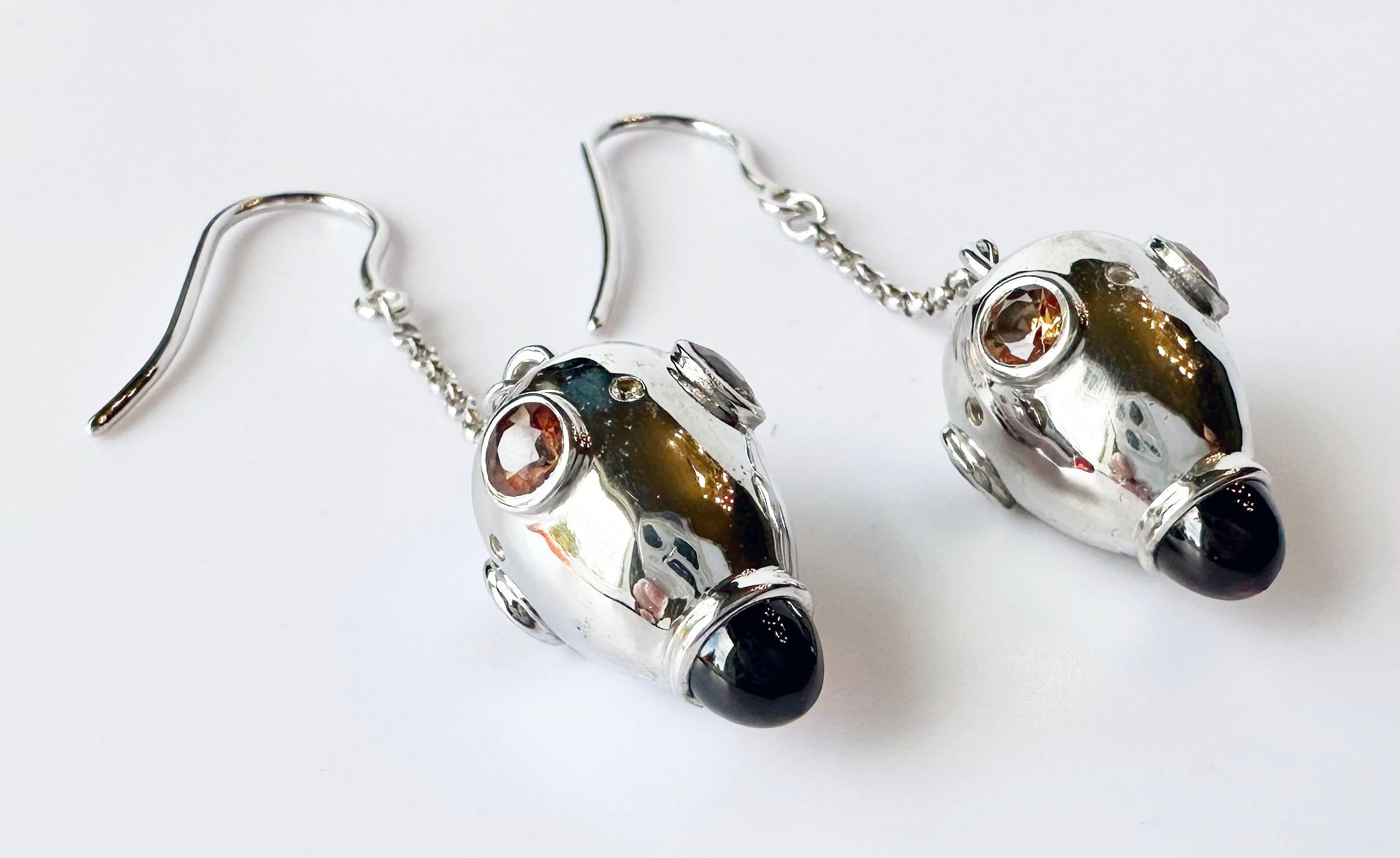 Silver Drop Earrings, Set with Pyrope Garnet Cabochons, Orange Sapphires and Diamonds. These spectacular dangles will be sure to catch attention as they are unique and one of a kind.

Originally from San Diego, California, Kary Adam lived in the