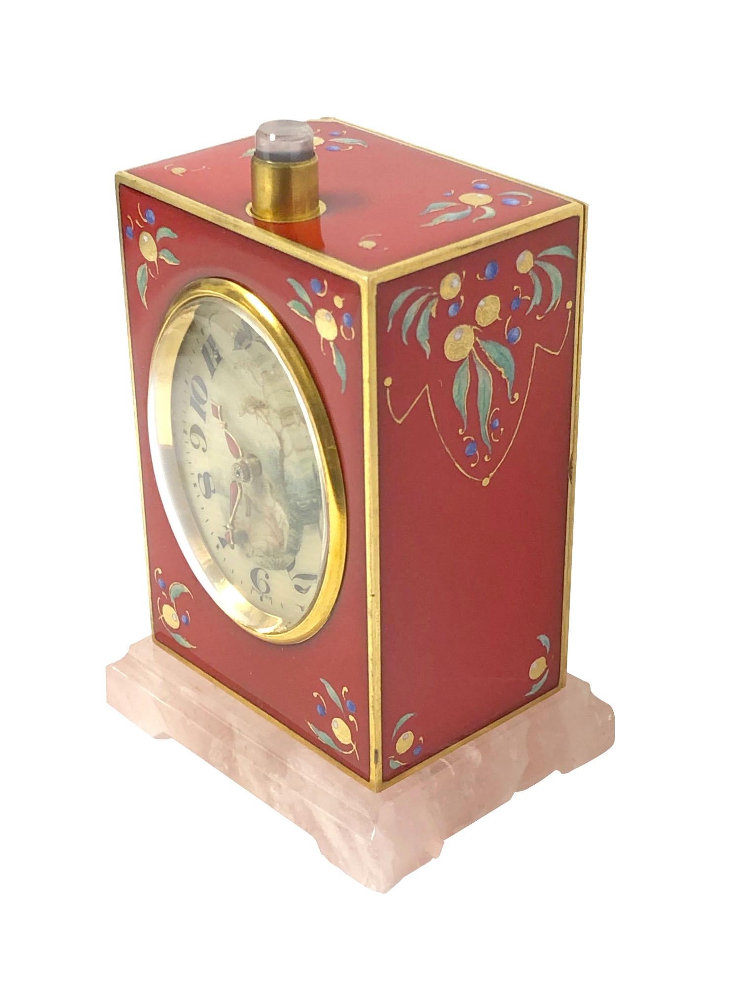 Circa 1920s Repeater Clock by D. Fresard Switzerland, Gold Gilt Sterling Silver case with Red Enamel measuring 3 X 2 X 1 1/4 inches, Rose Quartz Base and a Rose Quartz push on the case top. 11 Jewel, 8 Day key wind movement with Quarter Hour