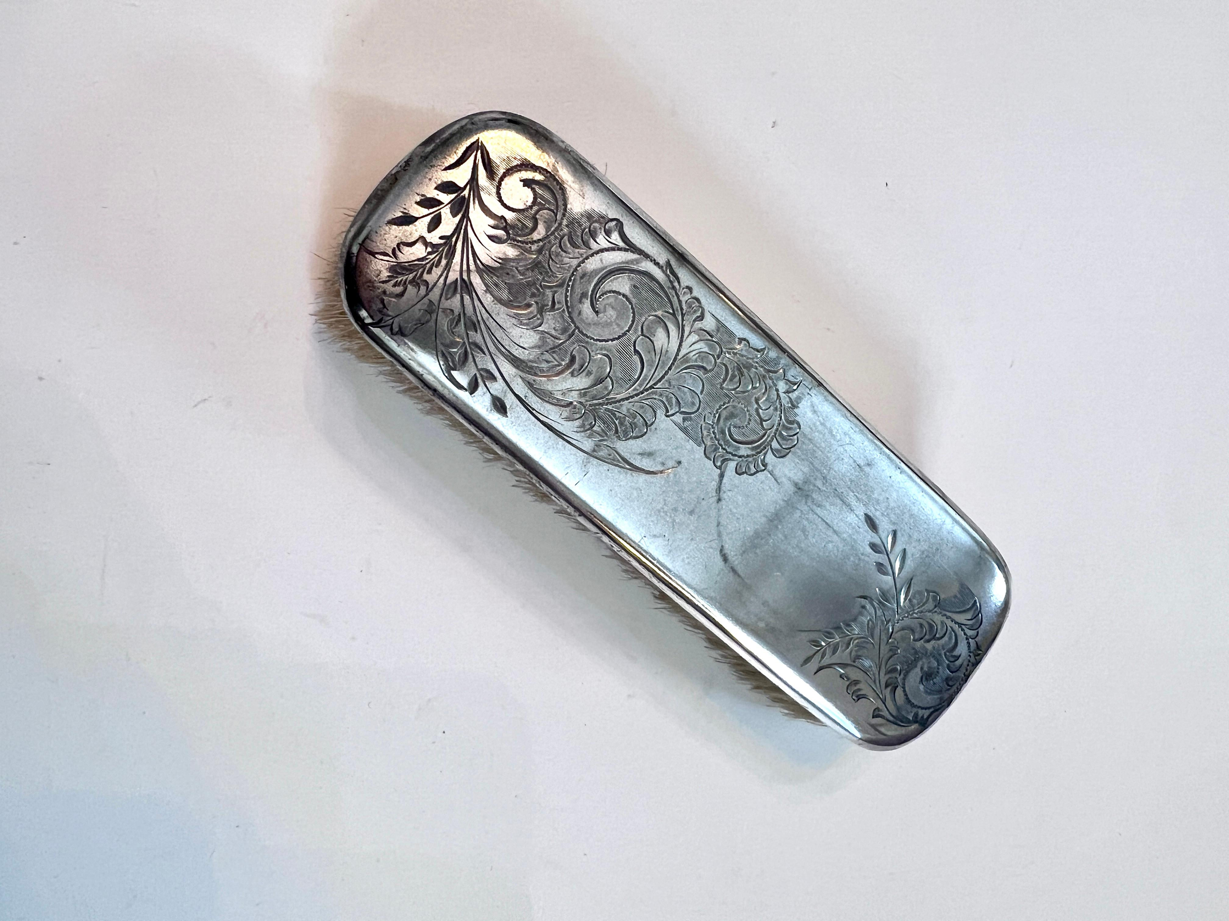 A beautiful Etched Silver Clothing Brush with natural Bristles.

The brush would be a compliment to any mens or women's closet or vanity and valet.  A wonderfully practical piece or perfect as decor.  Works like a charm on removing lint and dust