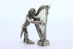 Silver figure of a musician playing the harp