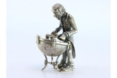 Silver figure of a musician playing the timpani