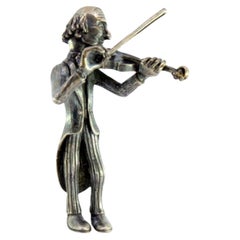 Silver figure of a musician playing the violin