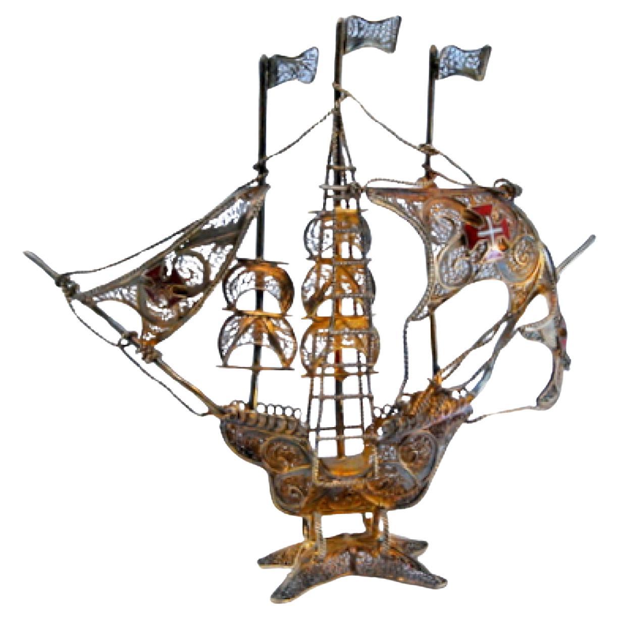 Silver filigree caravel with enameled crosses and scalloped base