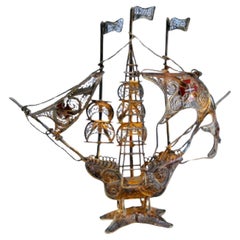 Silver filigree caravel with enameled crosses and scalloped base