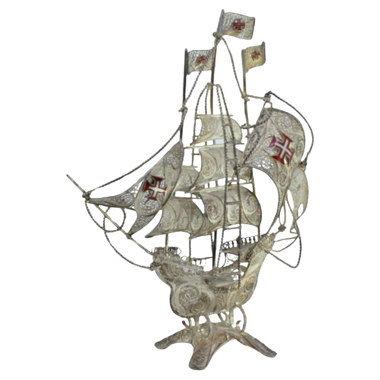 Silver filigree caravel with enameled crosses on four-leg base