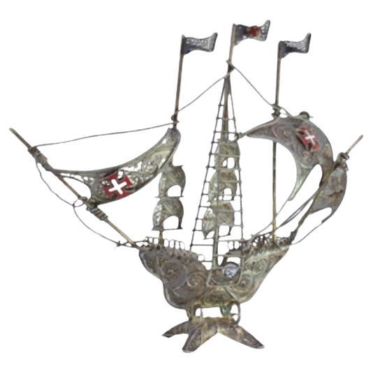 Silver filigree caravel with three flags and Portuguese symbols