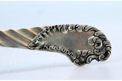 Silver fish fork with cut floral motifs & wavy monogrammed handle