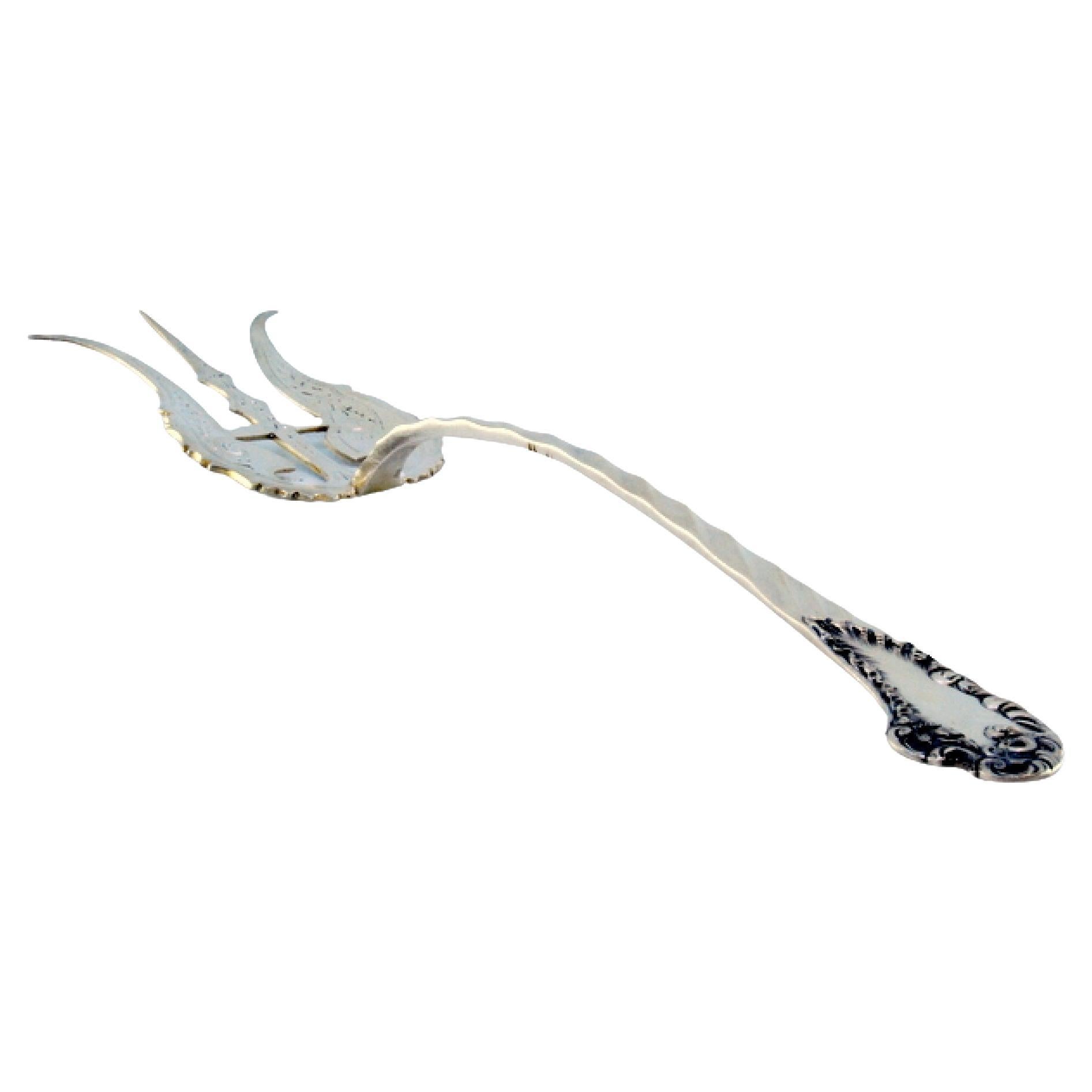 Silver fish fork with cut floral motifs 
wavy monogrammed handle For Sale
