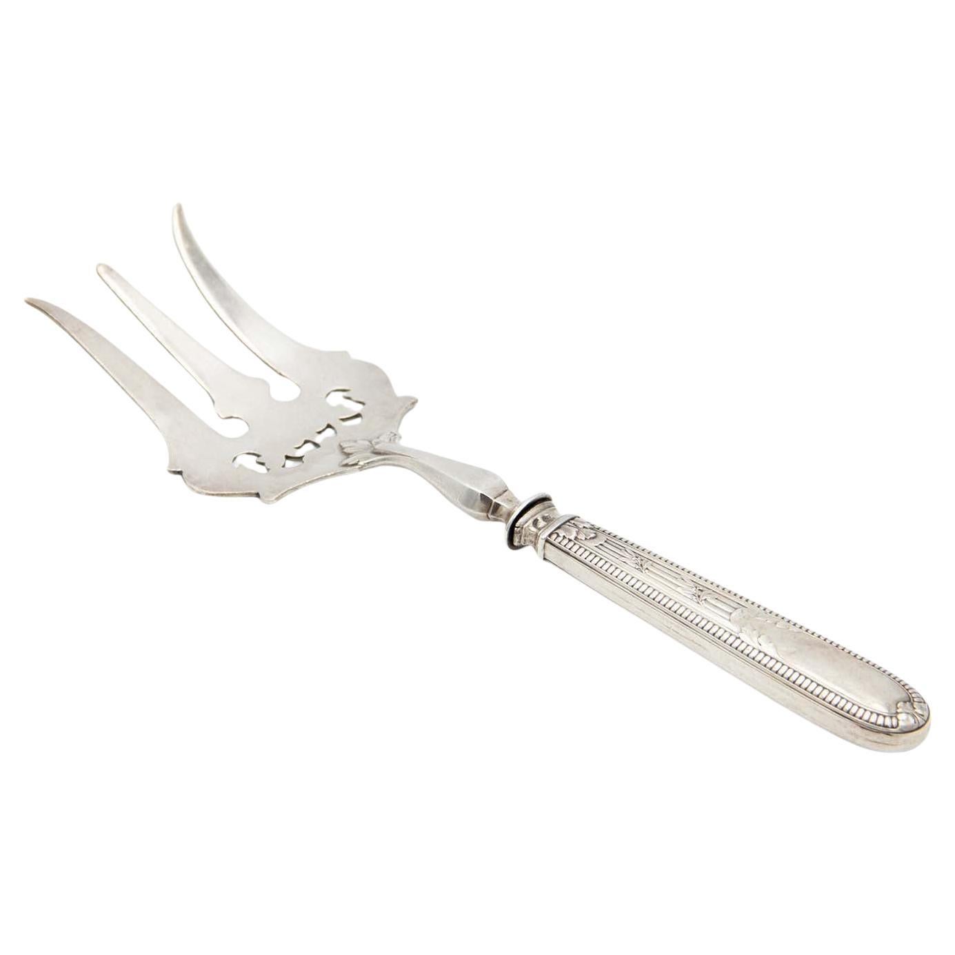 Silver fish fork with reliefs and detailed engravings on handle