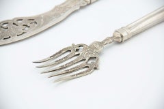 Silver fish knife and fork with cutouts