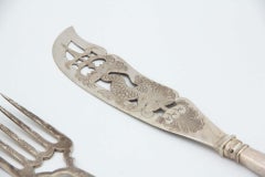 Silver fish knife and fork with cutouts