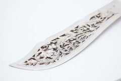 Silver fish knife and fork with cutouts