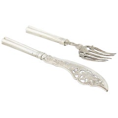 Silver fish knife and fork with cutouts