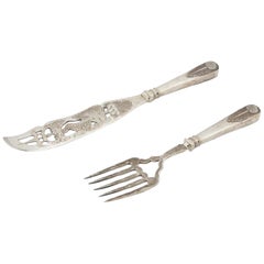 Silver fish knife and fork with cutouts