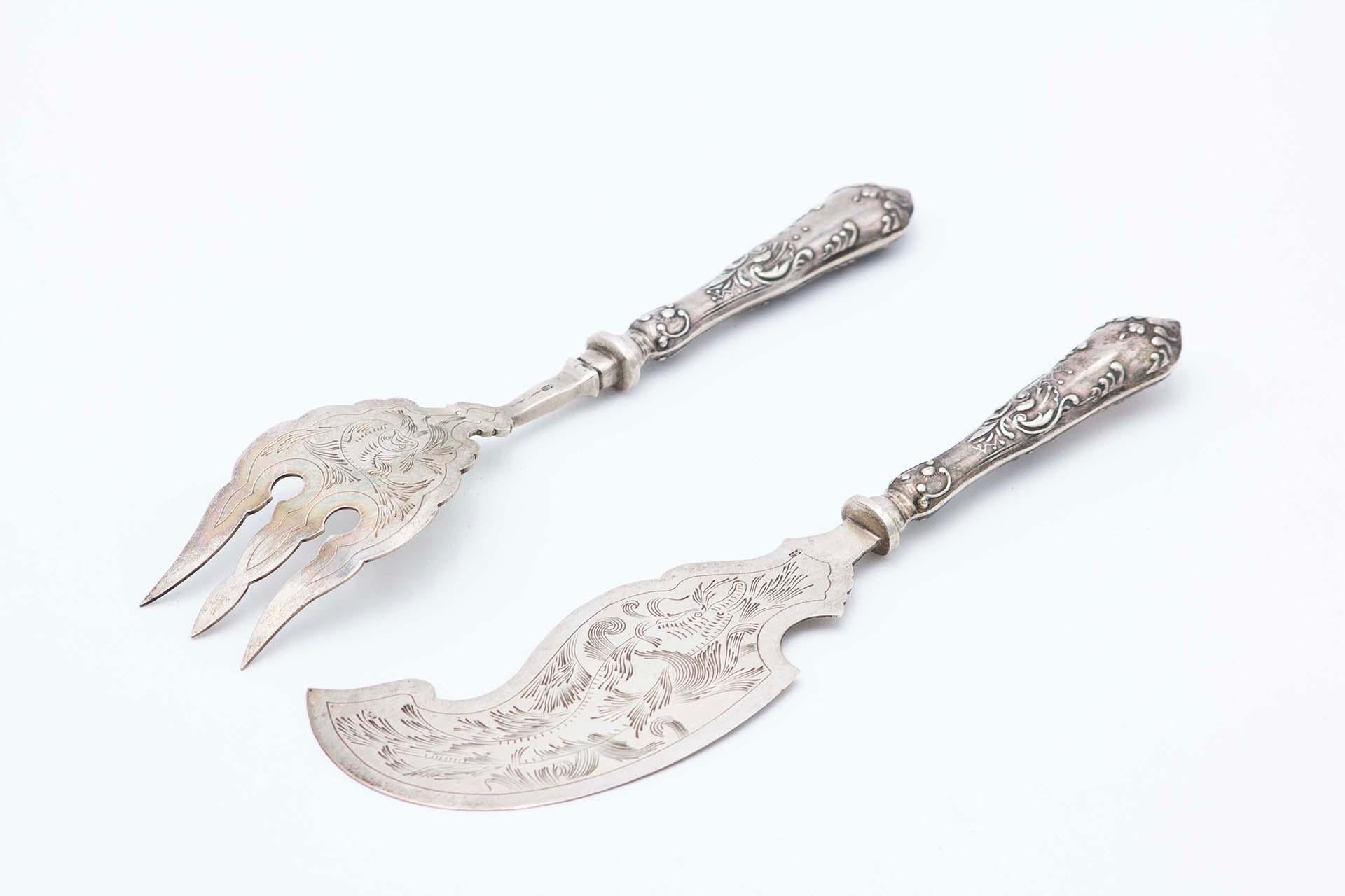 Silver fish knife and fork with engraving on the blades