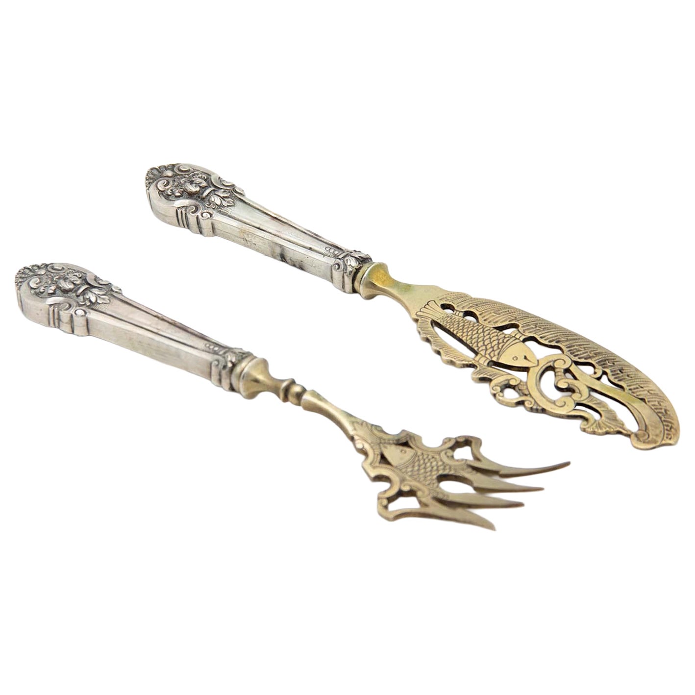 Silver fish knife and fork with gold trim and raised handles