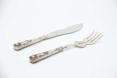 Silver fish knife and fork with reliefs on the handles
