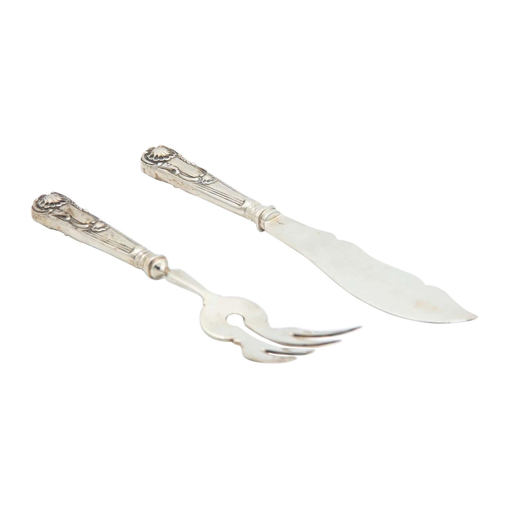 Silver fish knife and fork with reliefs on the handles